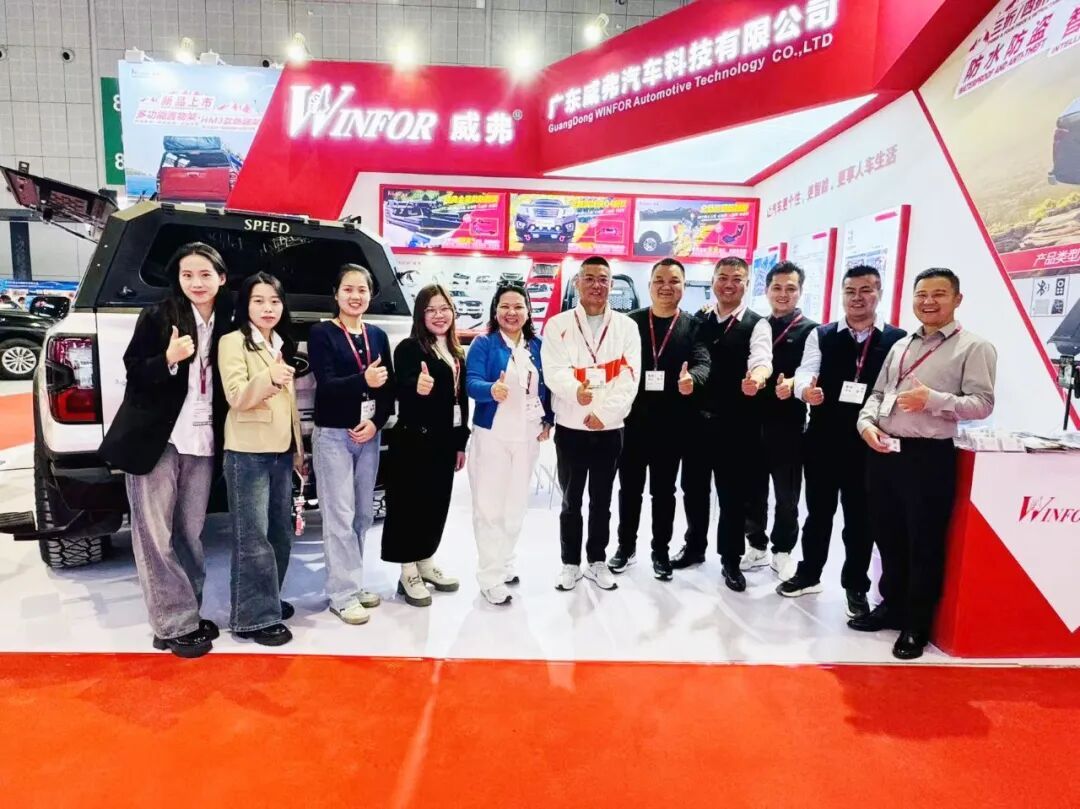 WINFOR team group photo with customers in front of booth 8.2E63 at Automechanika Shanghai 2024, with the red stand and product wall behind them