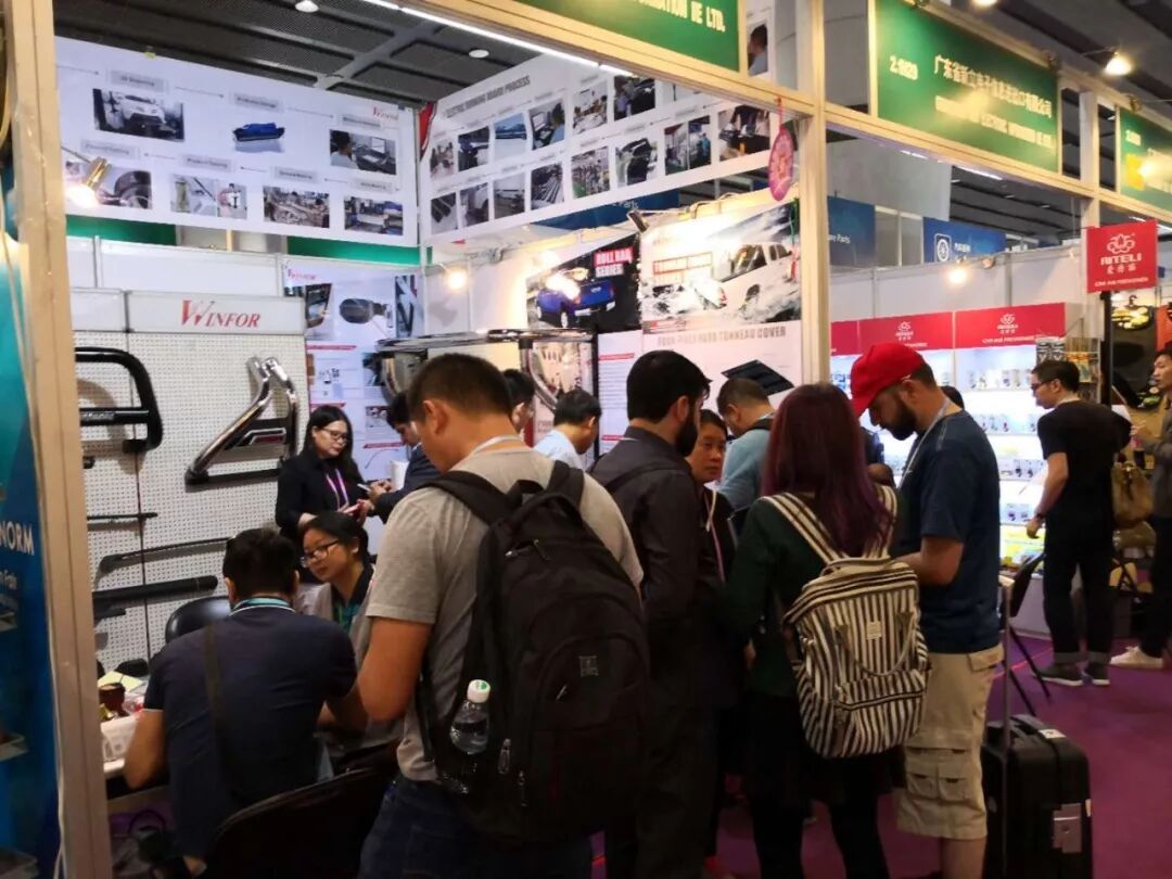 Busy aisle inside the Canton Fair Complex during the 123rd session, with continuous visitor traffic past the WINFOR pickup bed booth